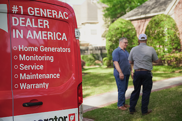 A Generator Supercenter technician talking toa homeowner who just purchased a whole home Generac Generator from Generator Supercenter.